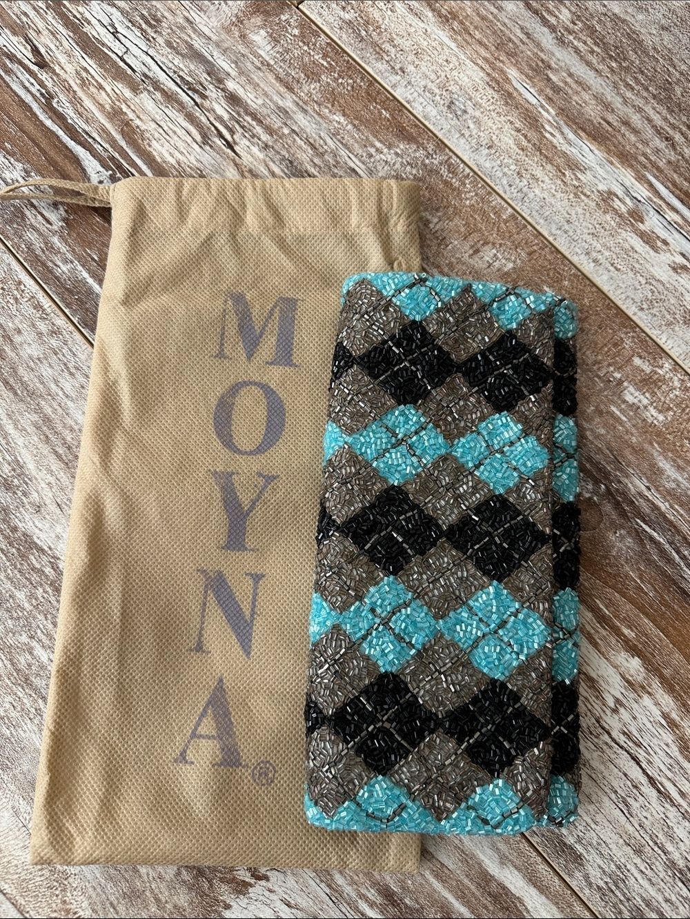 Moyna beaded clutch featuring a turquoise and black argyle pattern